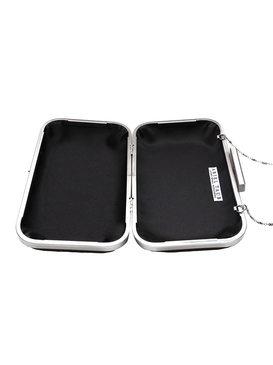 A modern design on clutches with a full open design to easily locate all of your belongings. The frame of this clutch is silver with a black satin lining.