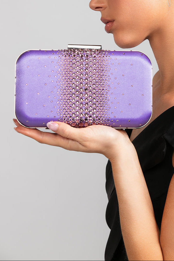 Model holding the Ella Austrian crystal clutch in lilac by Ariel Taub wearing a black top.
