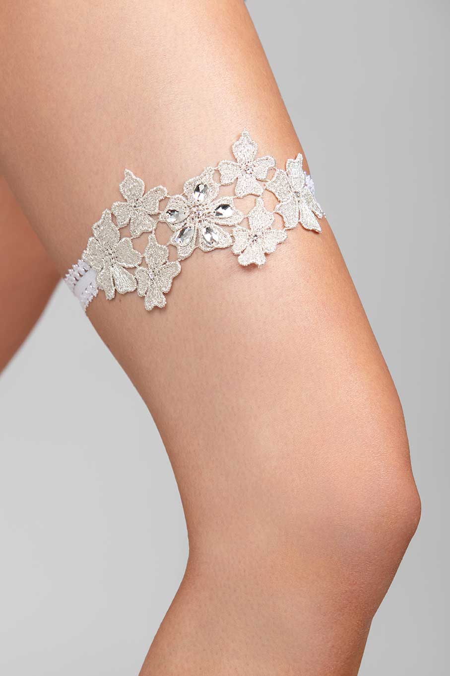 A metallic floral garter with crystal embellishments and a soft elastic band.