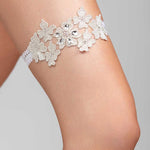 A metallic floral garter with crystal embellishments and a soft elastic band.