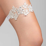 A metallic floral garter with crystal embellishments and a soft elastic band.