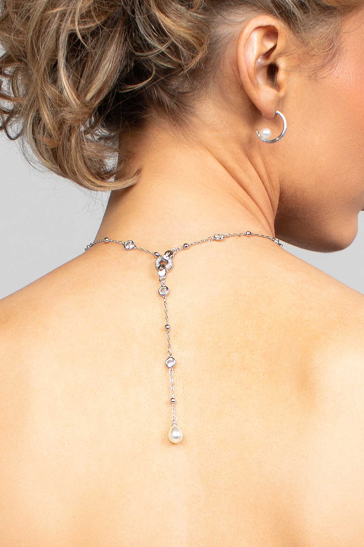 Model wearing the Palmer crystal and pearl lariat necklace in the back