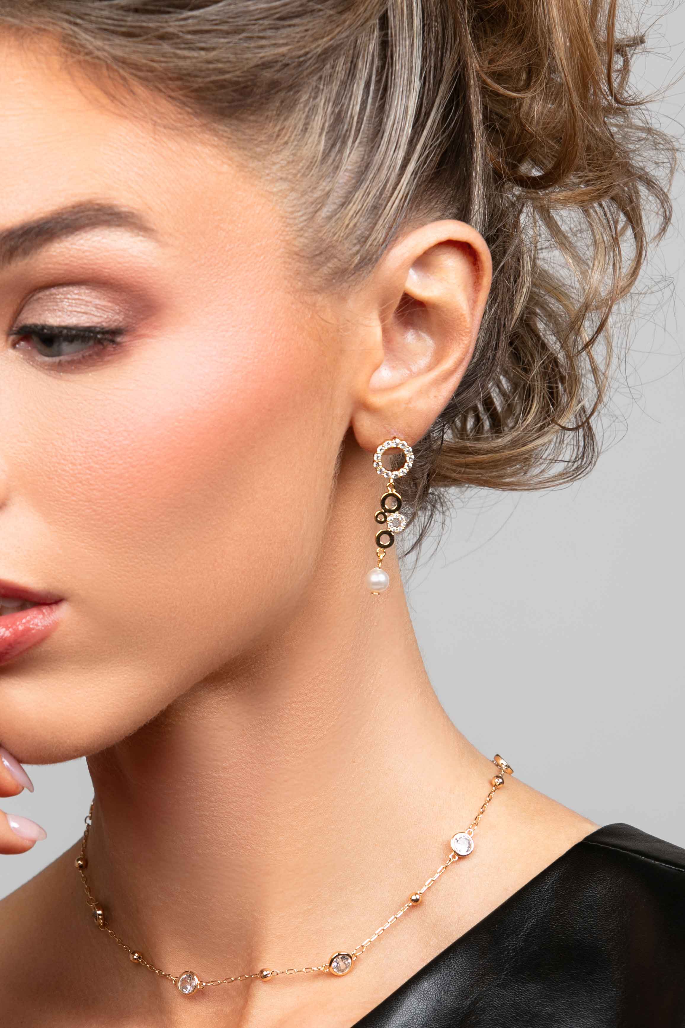 Model wearing the Phoebe CZ crystal multi circle earrings with a pearl drop at the bottom