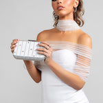 Model wearing the scarlet wrap paired with the Savannah scarf, Skye clutch, Sparkle hoop earrings and Stellar ring with a little white dress.