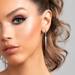 Close-up of model wearing silver Sloane spike drop earrings with pavé CZ crystals