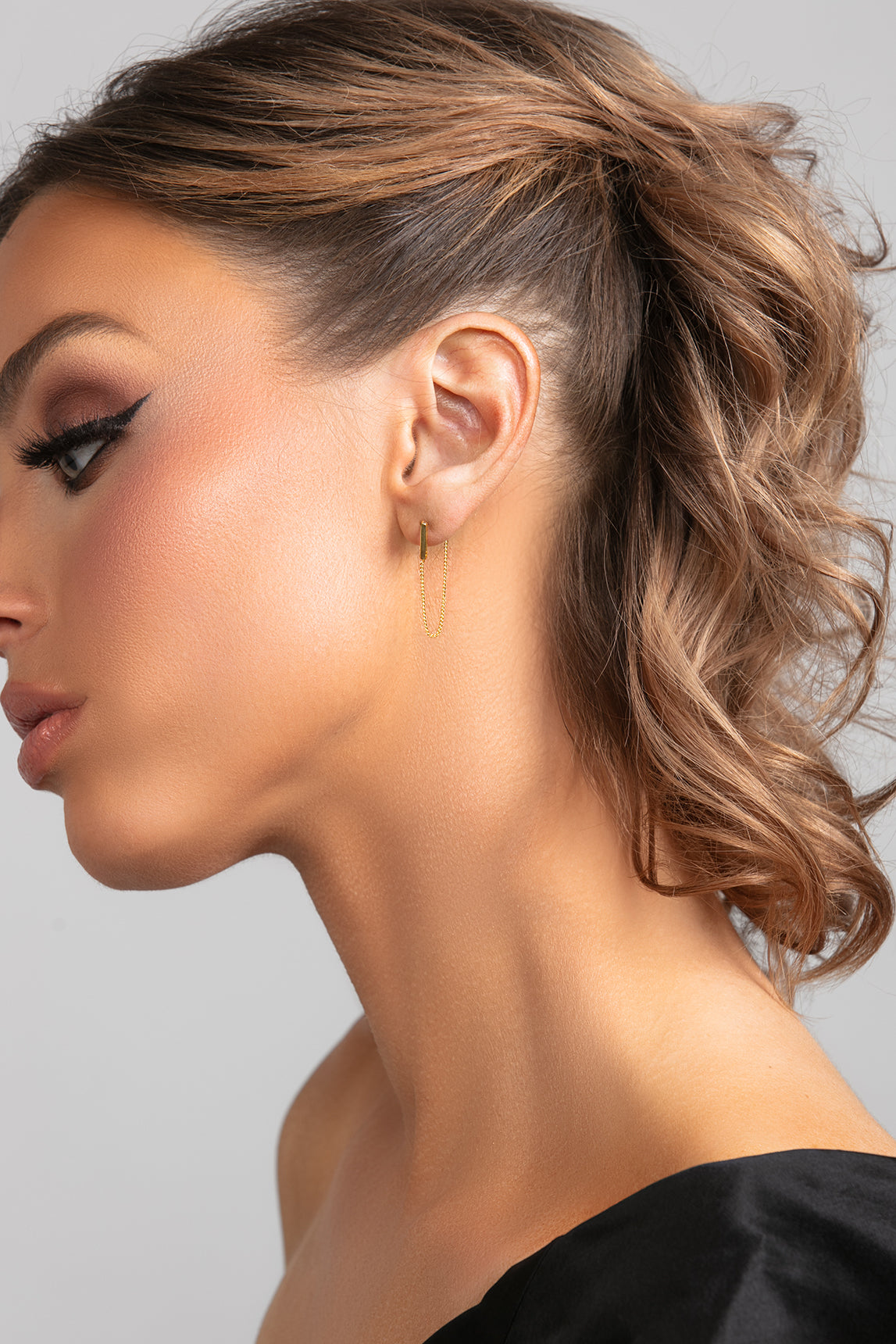 Sophia .0925 sterling silver bar earrings with single chain drop in gold on model.