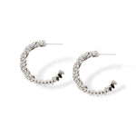 Sparkle hoop earrings made with CZ pave crystals that wrap around flat lay shot