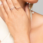 Woman wearing gold and silver split pave crystal and pearl rings