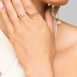 Woman wearing gold and silver split pave crystal and pearl rings