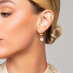 Model wearing Tessa gold matte crystal earrings by Ariel Taub