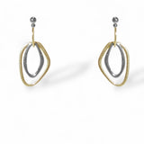 Pair of gold and silver earrings on a white background