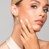 Model wearing Toni mixed metal modern drop earrings paired with the Tai stacked rings by Ariel Taub