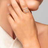 Model wearing stacked Ariel Taub Tai rings - split rings with pave crystals and pearls in gold and silver.