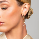 Model wearing Tracy gold Austrian pearl drop earrings by Ariel Taub
