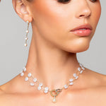 Model wearing Très Chic pearl choker necklace and Tori earrings