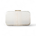 White clutch bag with pearl embellishments on a white background