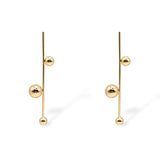 Sawyer drop earrings in gold, featuring a vertical bar with three polished gold spheres in a modern, minimalist design.