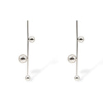 Sawyer earrings in silver tone with a slender vertical bar and spherical accents, offering a contemporary drop silhouette.