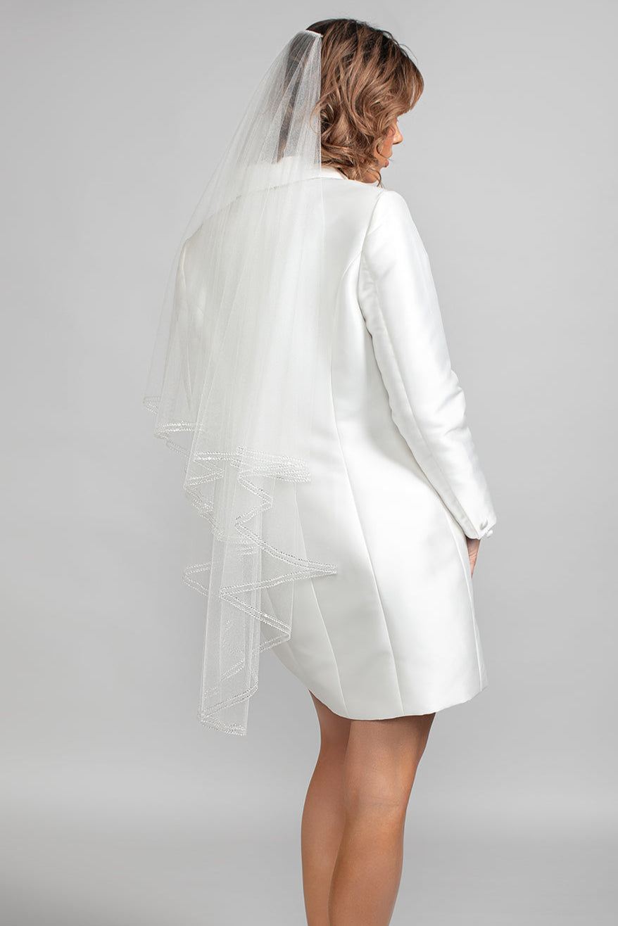 Back view of the Serenity wedding veil showing two soft fingertip-length layers trimmed in double rows of clear Austrian crystals.