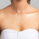 Model wearing Sutton silver lariat spike pave cz crystal necklace styled in the front with strapless dress
