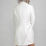 Back view of the Symphony veil with a soft cascade silhouette and sparkling crystals throughout, styled with a modern Andrea Osei BRIDE Renee blazer dress.