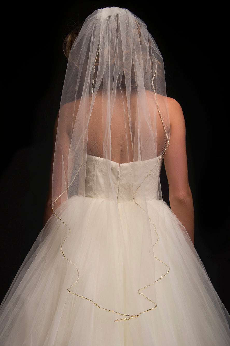 Single tier fingertip length veil with a beaded edge trim.