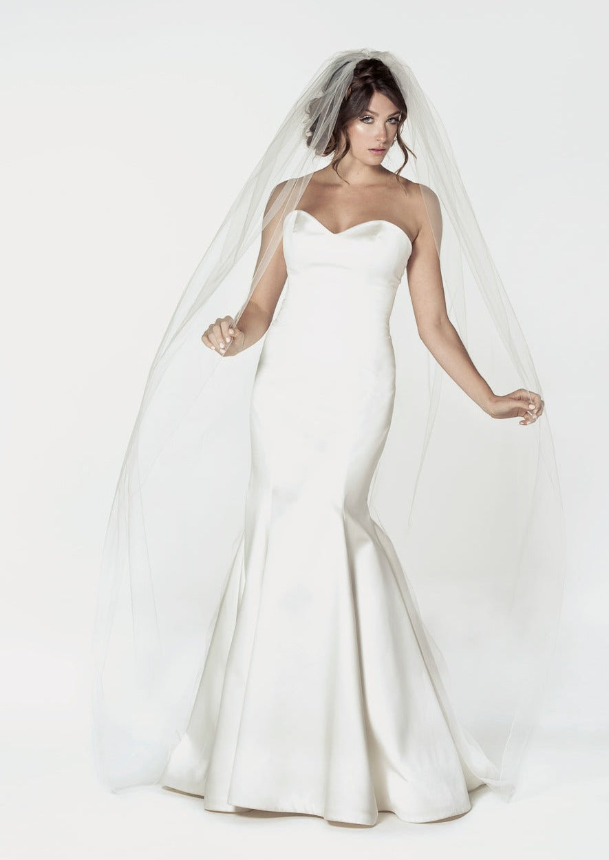 Standard cut chapel length bridal veil with a machine sewn pencil edge design. Available in matte or metallic color trim.