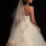Model wearing a two tier fingertip length veil with French Chantilly scallop lace trim along the bottom tier