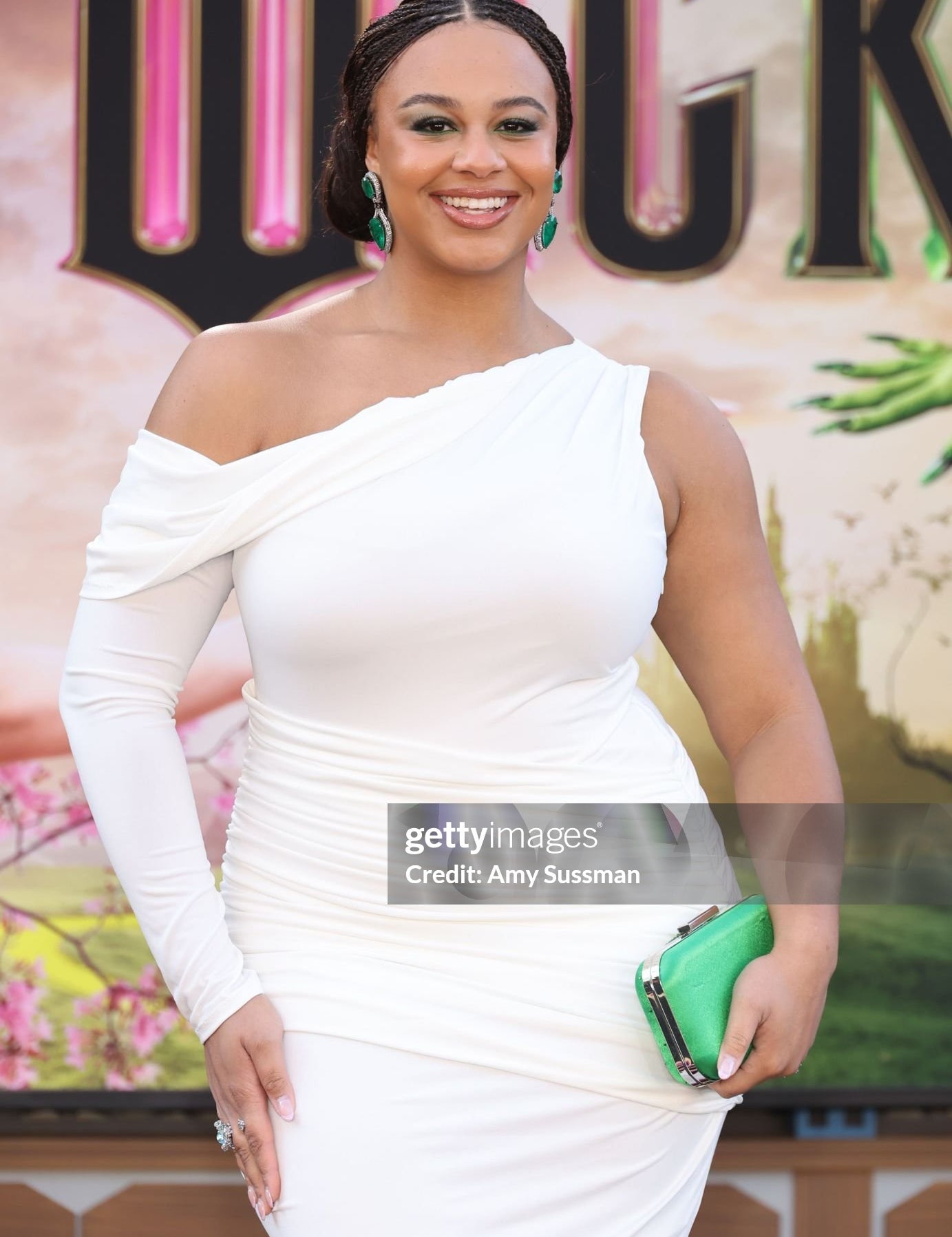 Nia Sioux dazzling on the red carpet at the Wicked Premiere in Los Angeles wearing the Ariel Taub Kelly Geen Austrian crystal Ella clutch