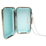 Open clutch with light blue interior and gold frame on a white background