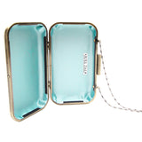 Open clutch with light blue interior and gold frame on a white background