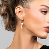 Model wearing pearl drop earrings in a lightning bold shape in silver