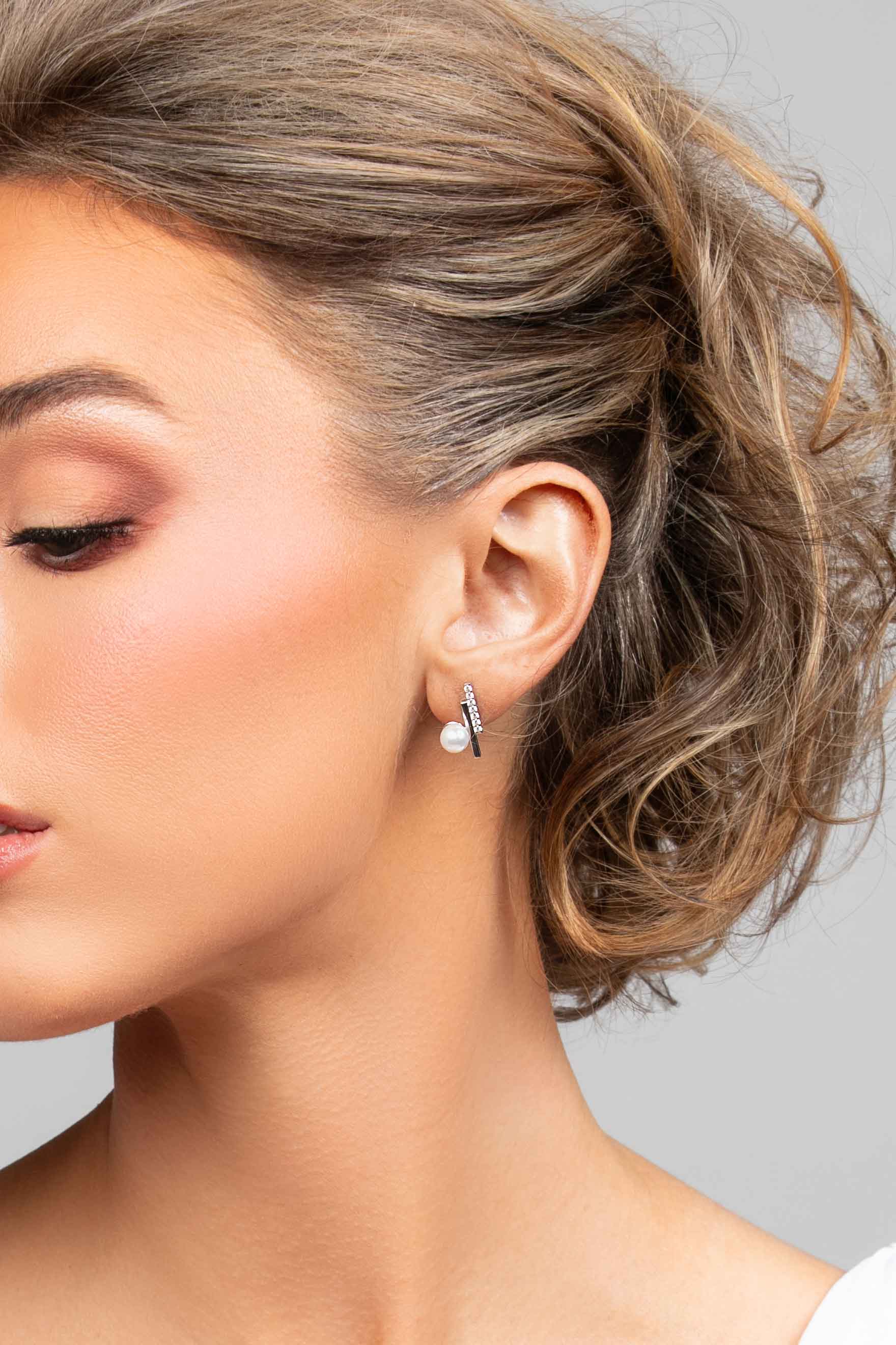 Model wearing the Paxton stud earrings in silver with CZ crystals and pearl