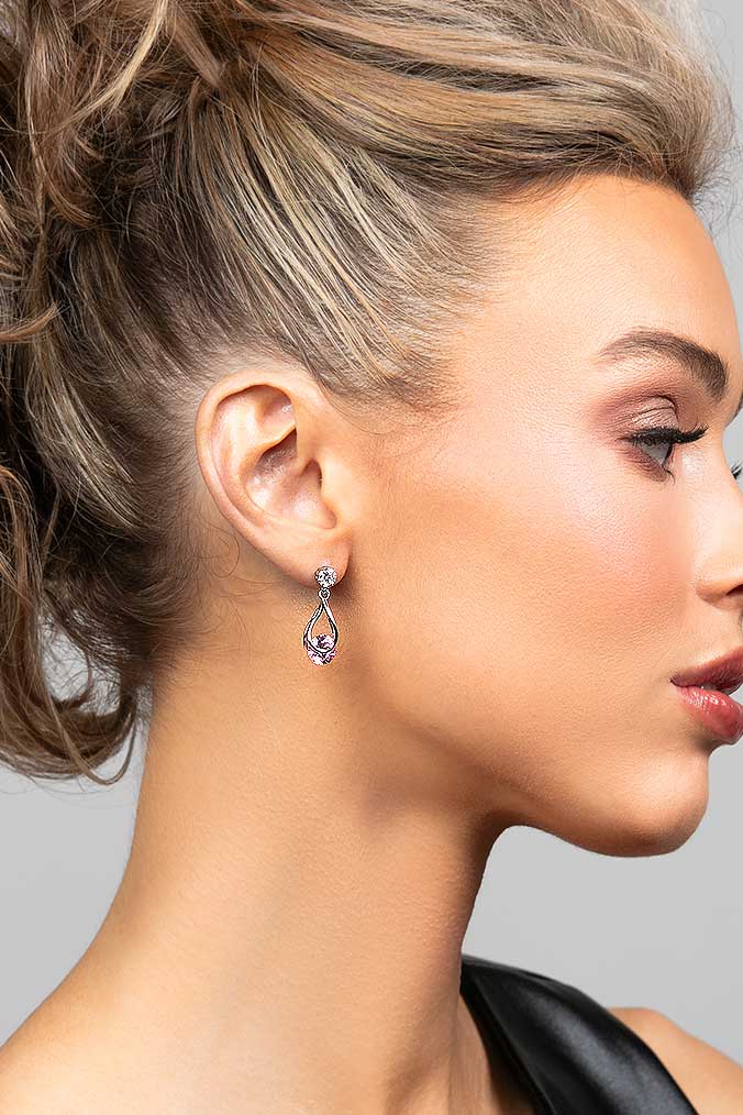 Model wearing the Perry pink cubic zirconia crystal drop earrings in silver