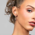 Model wearing the Perry pink cubic zirconia crystal drop earrings in gold