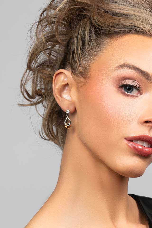 Model wearing the Perry topaz cubic zirconia crystal drop earrings in silver