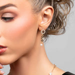 Model wearing the Phoebe CZ crystal multi circle earrings with a pearl drop at the bottom