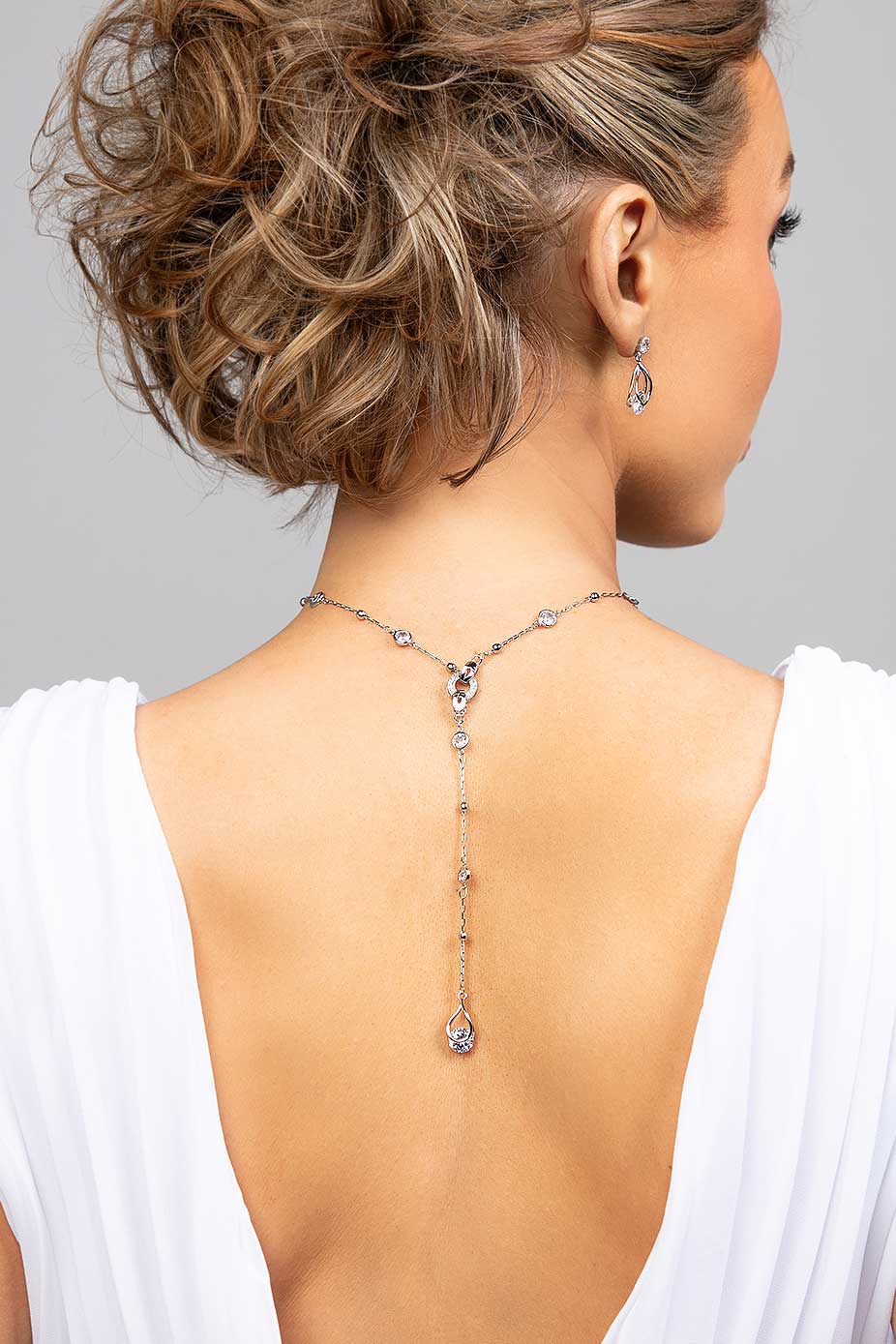 Model wearing the CZ crystal Presley lariat necklace in the back paired with the matching Perry earrings