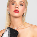 Rocking modern look with the glamorous Riley pave crystal and pearl bow long drop earrings paired with the silver crystal chocker and black and silver Austrian crystal Reese clutch.