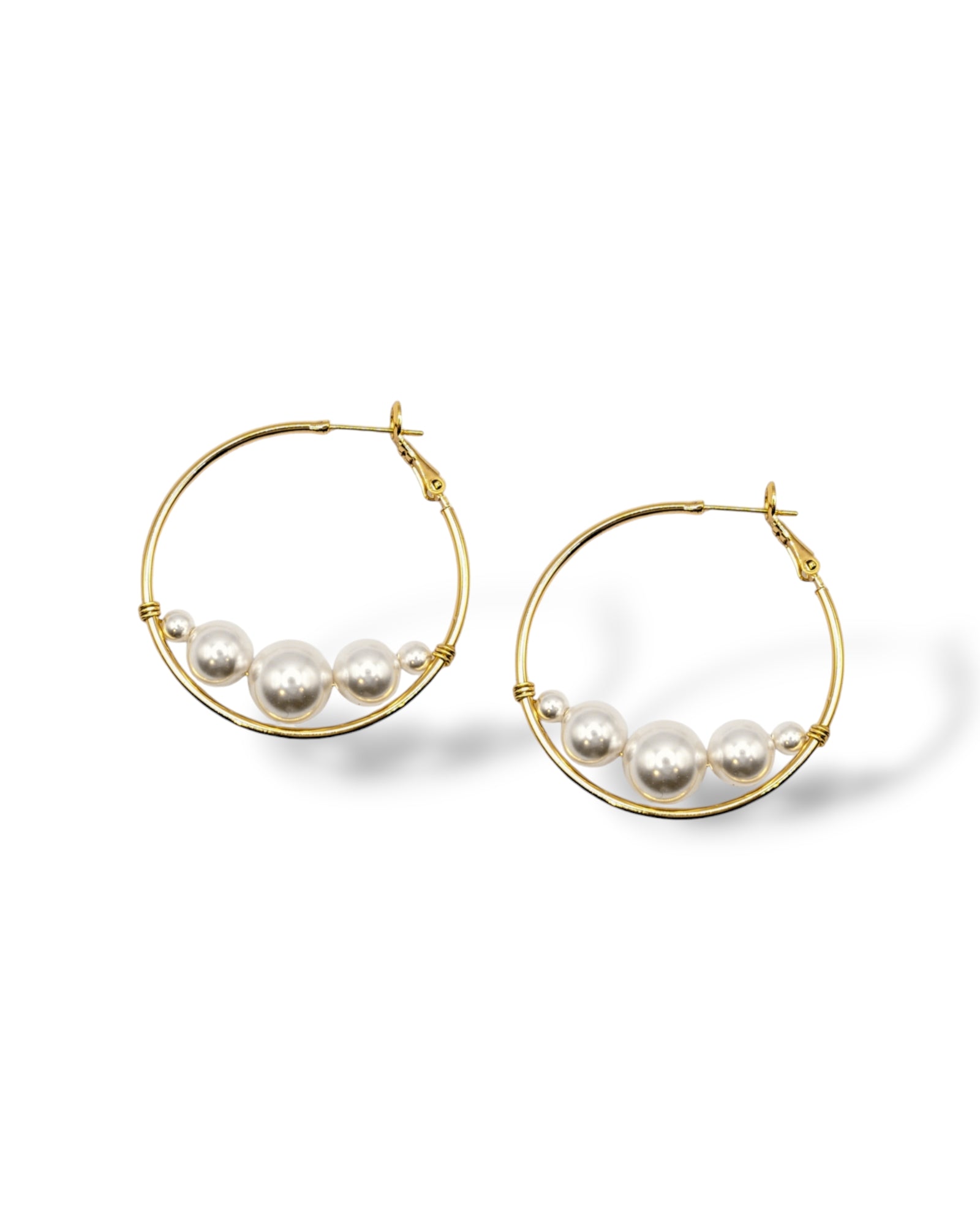 Large gold-plated hoop earrings with floating Austrian pearls along the bottom, perfect for modern fashion  or bridal looks.