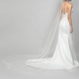 A modern cascading cathedral length wedding veil with sequin lace rose appliques placed along the train of the veil for the perfect shimmer to your bridal look.