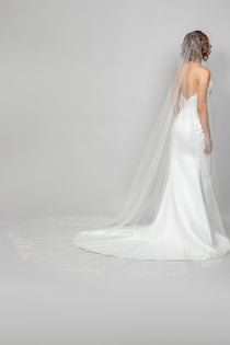 A modern cascading cathedral length wedding veil with sequin lace rose appliques placed along the train of the veil for the perfect shimmer to your bridal look.