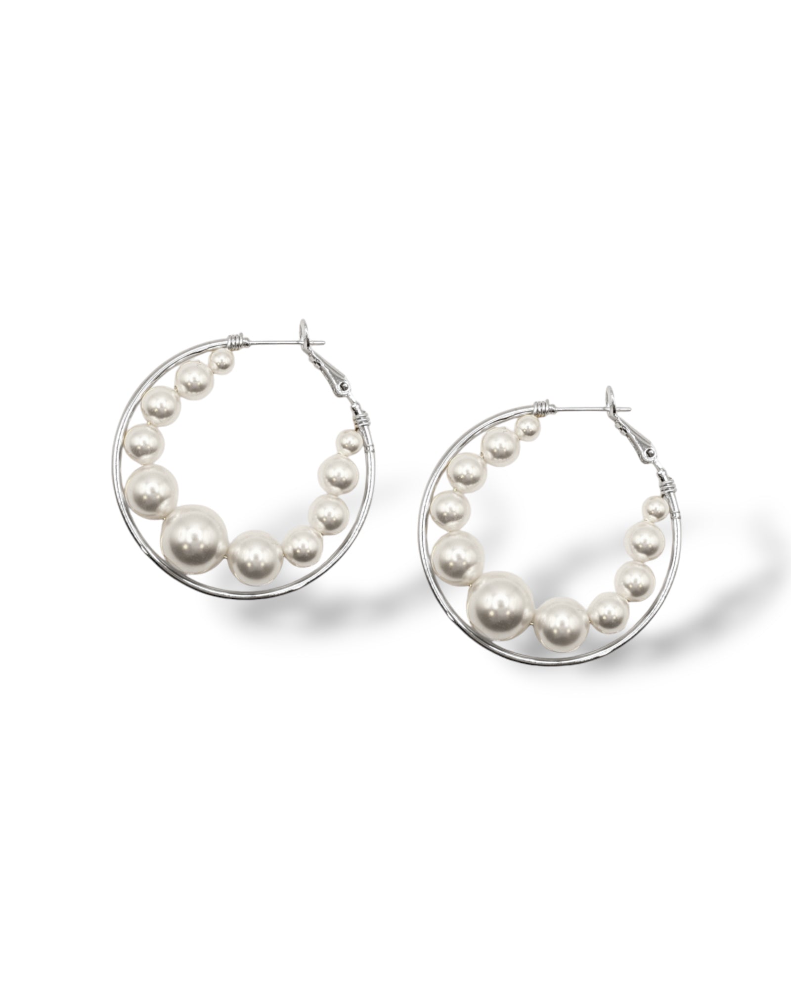 Rhodium-plated large hoops with floating Austrian pearls, designed for modern and versatile wear perfect for everyday fashion or glamorous bridal looks.