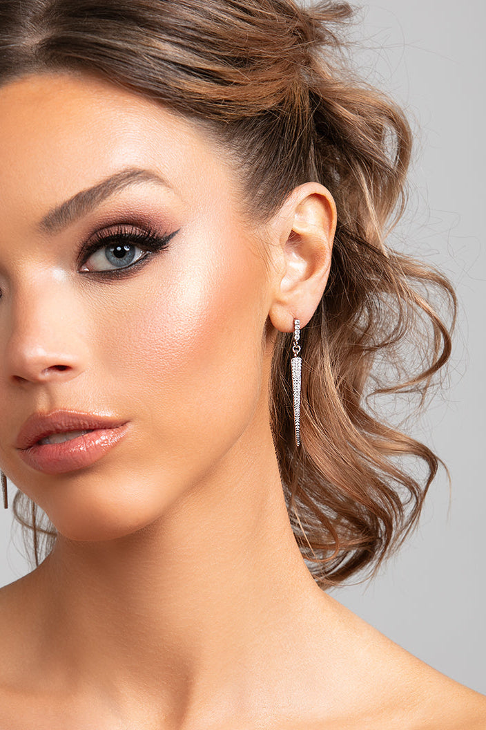 Close-up of model wearing silver Sloane spike drop earrings with pavé CZ crystals
