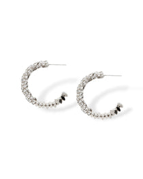 Sparkle hoop earrings made with CZ pave crystals that wrap around flat lay shot