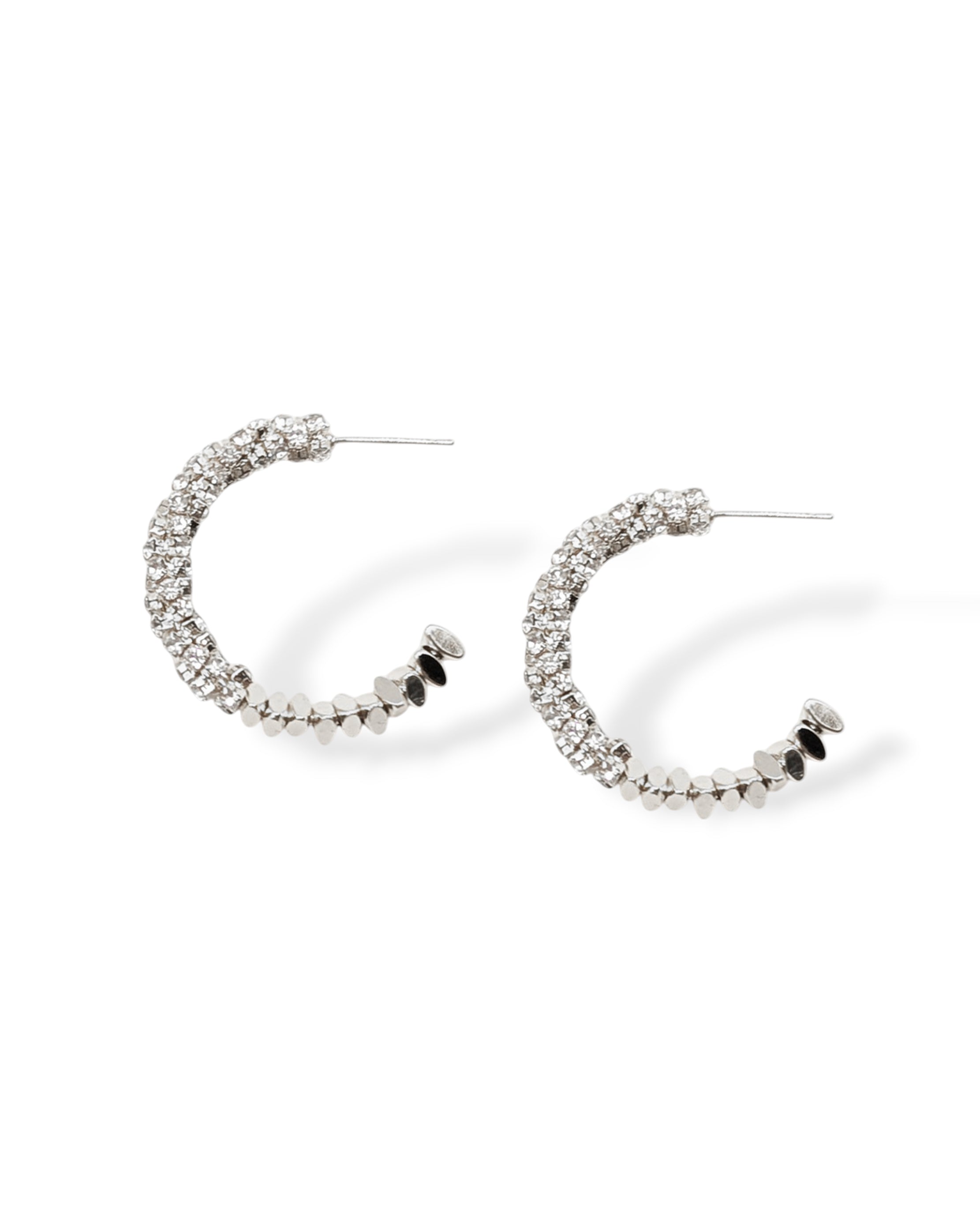 Sparkle hoop earrings made with CZ pave crystals that wrap around flat lay shot