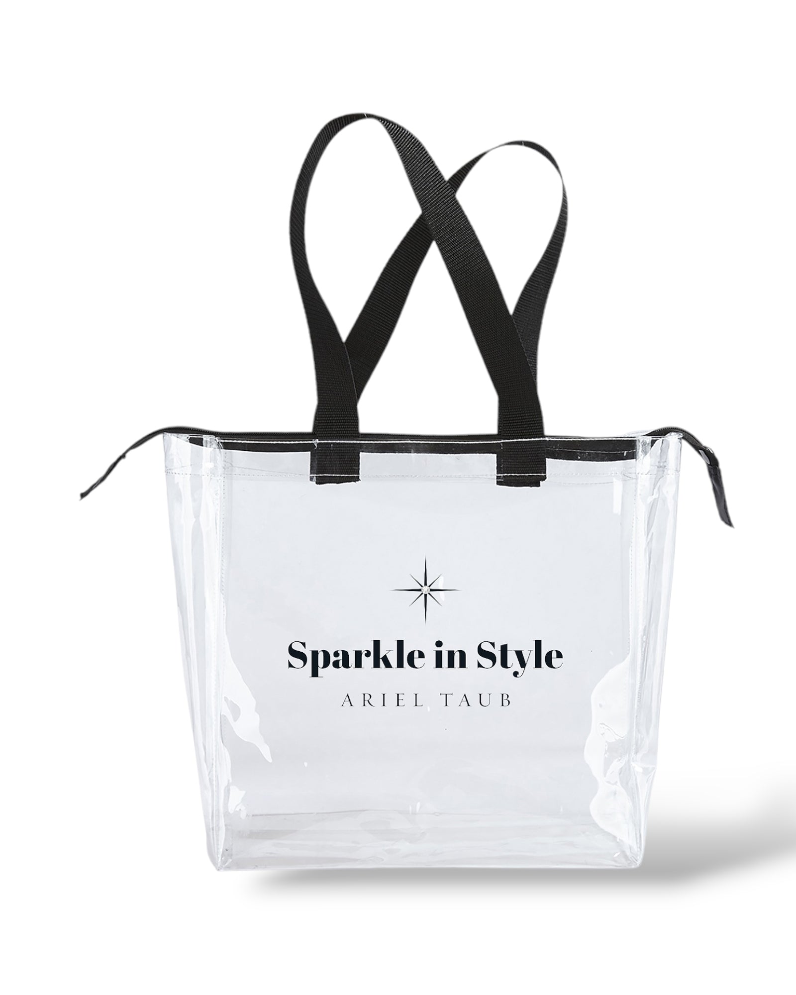 Sparkle in Style clear tote bag by Ariel Taub – Medium-sized transparent tote with black handles and zipper, featuring the phrase 'Sparkle in Style' on the front. Stylish and functional design, perfect for everyday use, travel, or shopping. A modern accessory that combines practicality with chic branding.