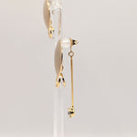 Side view of Stacey gold earrings showing dimensional drop design