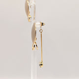 Side view of Stacey gold earrings showing dimensional drop design
