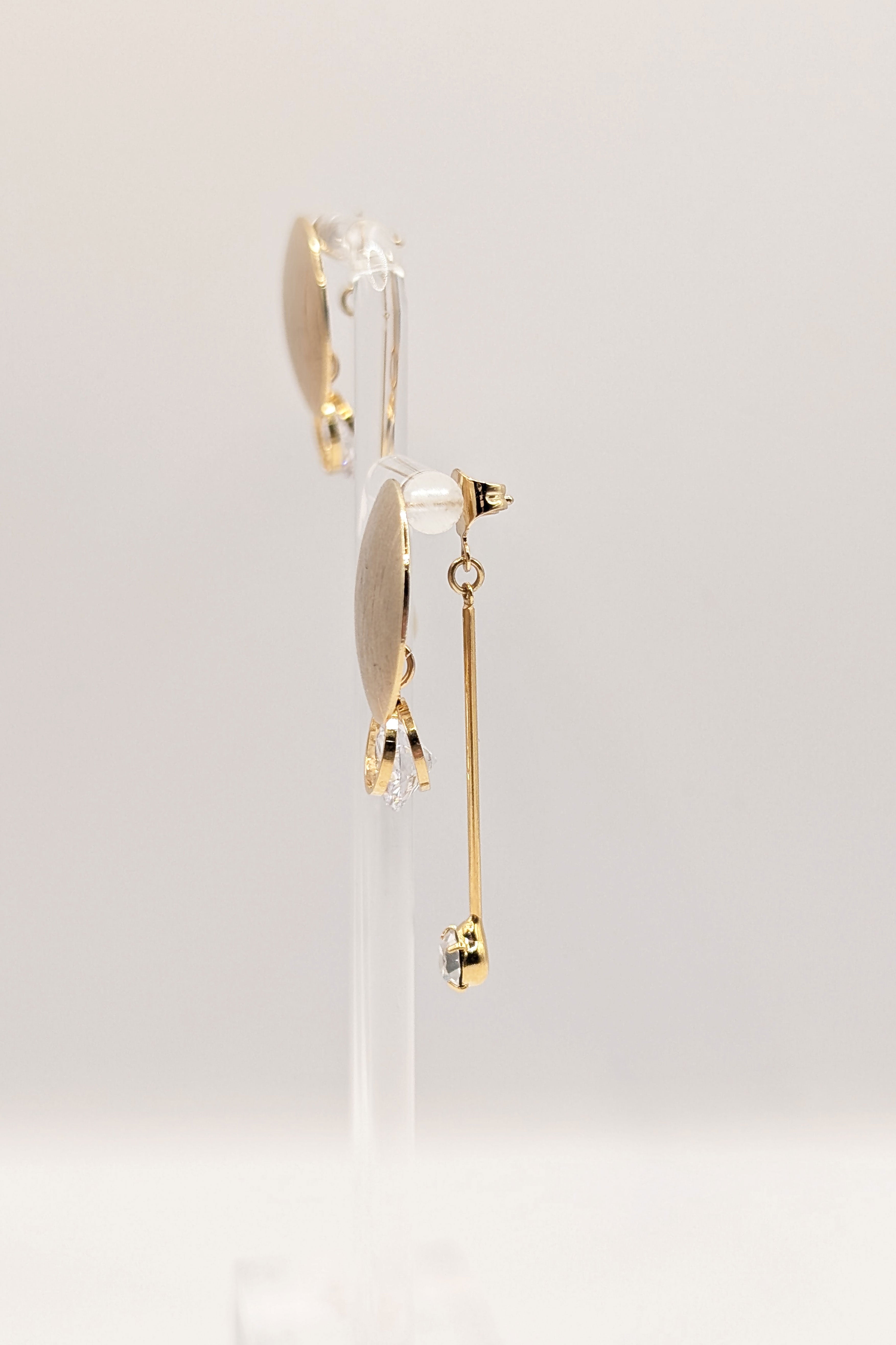 Side view of Stacey gold earrings showing dimensional drop design